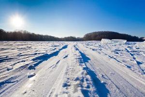 ski track at snow field in cold winter day photo