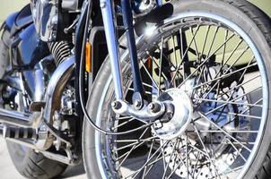 Fragment of chromed shiny wheel of old classic motorbike photo