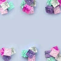 Piles of a small colored gift boxes with ribbons lies on a violet background photo