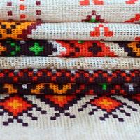 Stack of traditional Ukrainian folk art knitted embroidery patterns on textile fabric photo