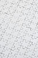 Close up texture of a white jigsaw puzzle in assembled condition. Top view. Many components of a large whole mosaic are united photo