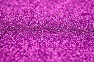Pink decorative sequins. Background image with shiny bokeh lights from small elements photo