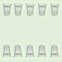 Pattern of many small shopping carts on a lime background photo