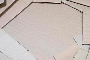 Background image with a lot of beige cardboard paper, which is used to make boxes for the transport of home appliances and postal parcels. Carton texture photo