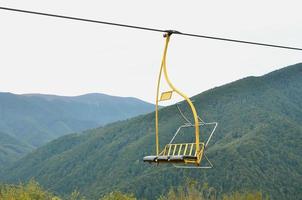 The seats of the cable car on the background of Mount Makovitsa, one of the Carpathian Mountains photo