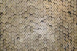 Pattern of 12 gauge cartridges for shotgun bullets. Shells for hunting rifle close up. Backdrop for shooting range or ammunition trade concepts photo