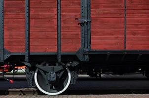 The side of the old brown wooden freight car with the wheel of the times of the Soviet Union photo