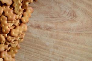 Many salted crackers on a cutting board with copy space photo