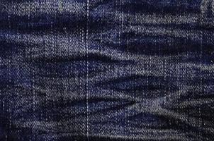 Detailed texture of dark denim cloth photo