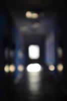 The blurred image of gloomy corridor of a neglected public building. Defocused picture of a public space in a poor residential high-rise building photo