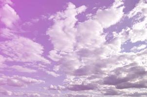 A blue cloudy sky with many small clouds blocking the sun photo