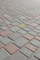 The texture of street alleys in the form of a mosaic made of processed paving stones in sunlight photo