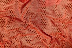 Sport clothing fabric texture background, top view of red cloth textile surface photo