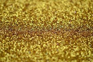 A huge amount of yellow decorative sequins. Background texture with shiny, small elements that reflect light in a random order. Glitter texture photo