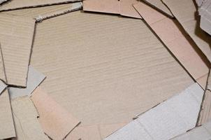 Background image with a lot of beige cardboard paper, which is used to make boxes for the transport of home appliances and postal parcels. Carton texture photo