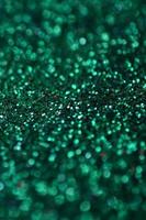 A huge amount of green decorative sequins. Background image with shiny bokeh lights from small elements photo