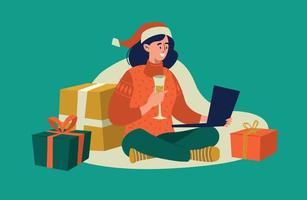 Online greetings for the new year. A girl in a santa claus hat and a glass of champagne sits on the floor with a laptop. Vector image.