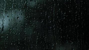 Rain drops on the glass. Small raindrop rests on glass while raining. video