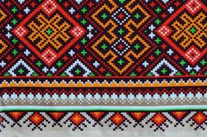 Traditional Ukrainian folk art knitted embroidery pattern on textile fabric photo