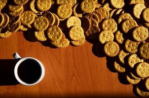 Small coffee cup and salted cracker photo