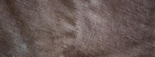 The texture of a very old brown sack cloth. Retro texture with canvas material. Background image with copy space photo