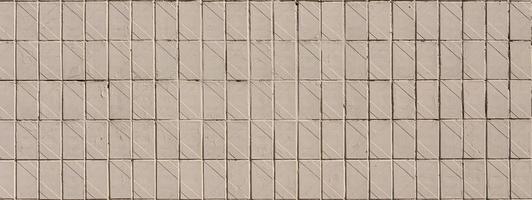 Old Soviet beige wall tiles. The texture of the classical outer tile, which was revetted by buildings during the times of the Soviet Union photo