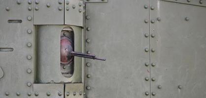 The texture of the wall of the tank, made of metal and reinforced with a multitude of bolts and rivets. Images of the covering of a combat vehicle from the Second World War with a guided machine gun photo