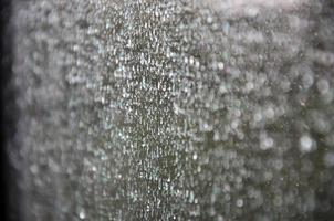 Background image of rain drops on a glass window. Macro photo with shallow depth of field