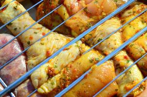 Marinated chicken legs on hot BBQ charcoal field grill photo