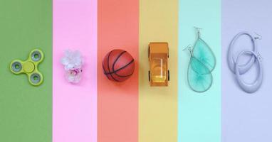 Trendy pastel composition with earrings, sunglasses, beverage can, basketball ball, toy truck, flower and spinner photo