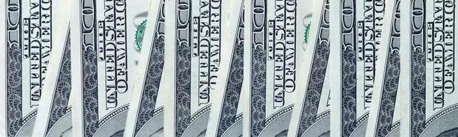 Abstract backdrop with many hundred dollar bills close up photo