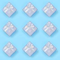 A lot of blue gift boxes lies on texture background of fashion pastel blue color paper in minimal concept photo