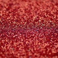 Crimson red decorative sequins. Background image with shiny bokeh lights from small elements photo