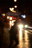 Blurred night scene of traffic on the roadway. Defocused image of cars traveling with luminous headlights. Bokeh Art photo