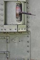The texture of the wall of the tank, made of metal and reinforced with a multitude of bolts and rivets. Images of the covering of a combat vehicle from the Second World War with a guided machine gun photo