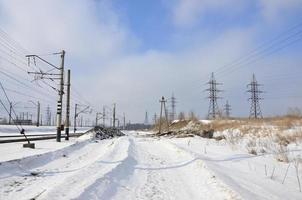 Winter landscape with towers of transmission lines photo