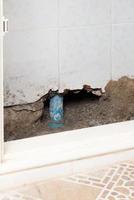 Concrete walls in the shade that have been smashed or destroyed to find holes for water leaks. Home repair concept. photo