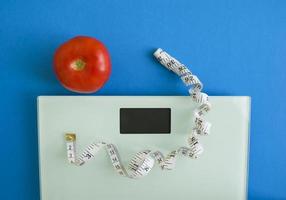 Electronic scales, centimeter tape and tomato photo