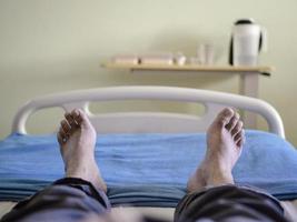 A patient lying on a hospital bed photo