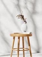 3d wooden chair with plant in vase and white books against white concrete wall. 3d rendering of realistic presentation for product advertising. 3d illustration. photo