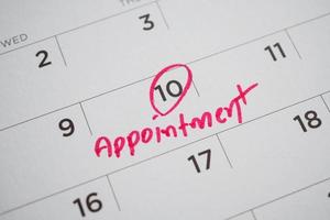 important appointment schedule write on white calendar page date close up photo