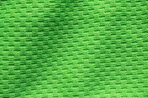 Green sports clothing fabric football shirt jersey texture close up photo