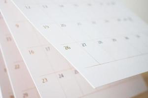 Calendar page flipping sheet close up blur background business schedule planning appointment meeting concept photo