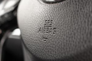 Safety airbag sign on car steering wheel with horn icon photo