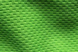 Green sports clothing fabric football shirt jersey texture close up photo