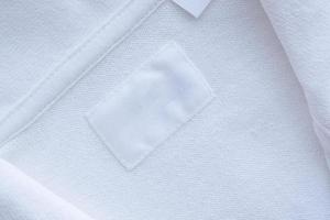 Blank white clothes label on new shirt background photo