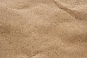 Brown crumpled paper recycled kraft sheet texture background photo