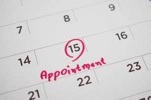 important appointment schedule write on white calendar page date close up photo