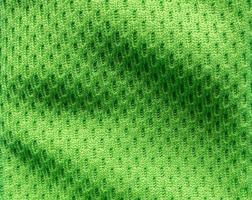 Green sports clothing fabric football shirt jersey texture close up photo