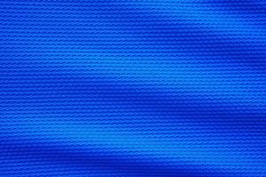 Blue football jersey clothing fabric texture sports wear background, close up top view photo